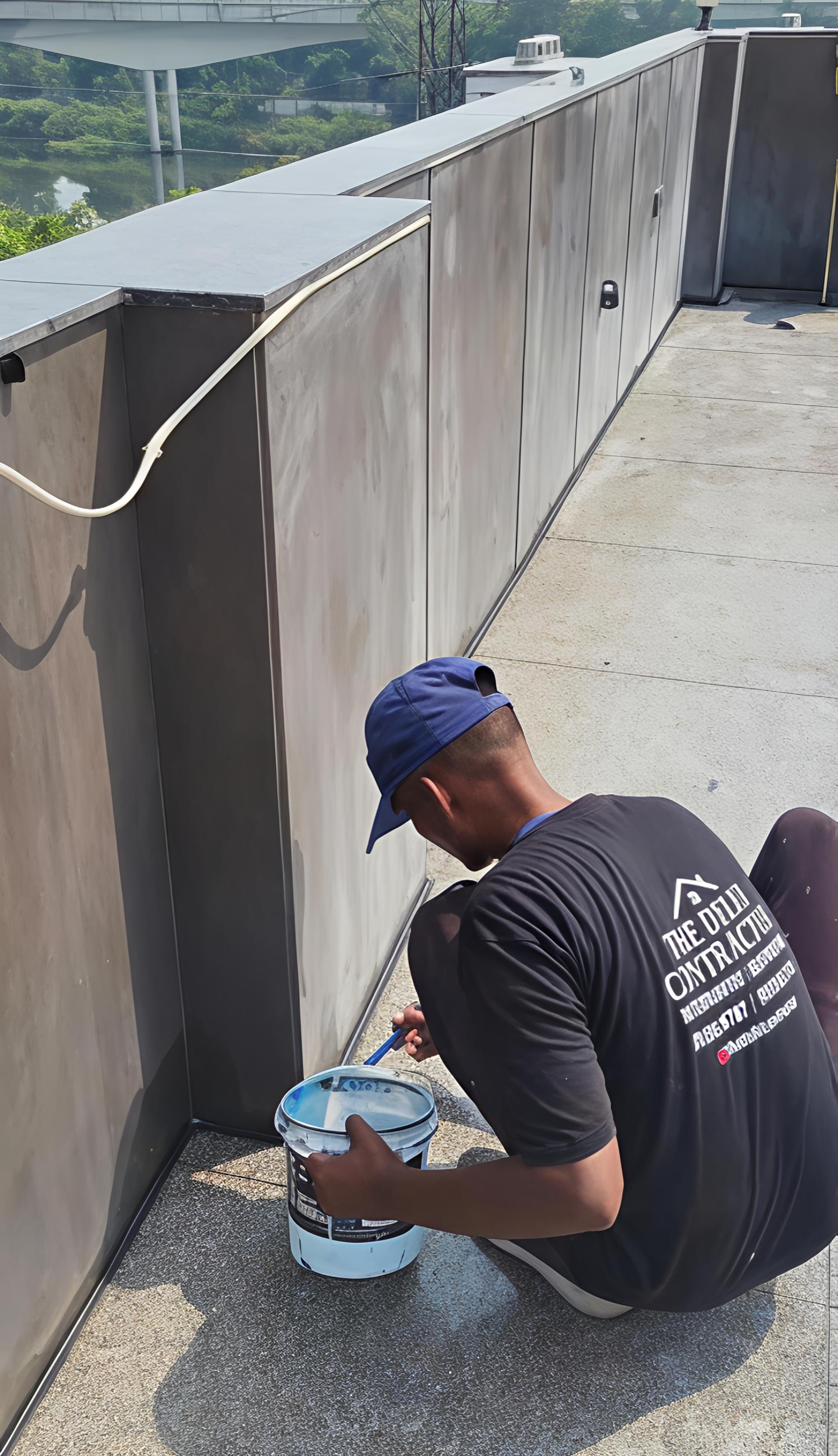The Delhi Contractor crew applying transparent waterproofing across a tiled rooftop in Punjabi Bagh West.
